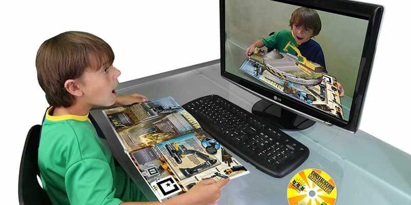 Child at desk with games magazine and AR computer