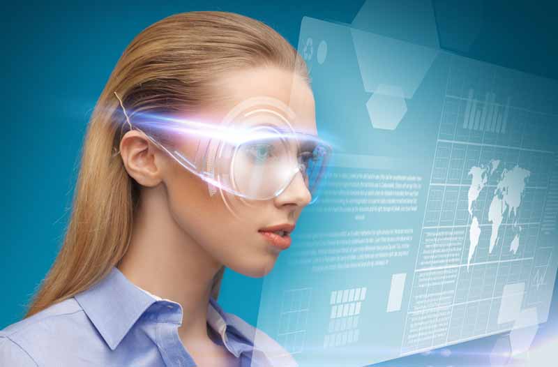 Woman with long blonde hair wearing smart glasses looking at a digital screen with infographics