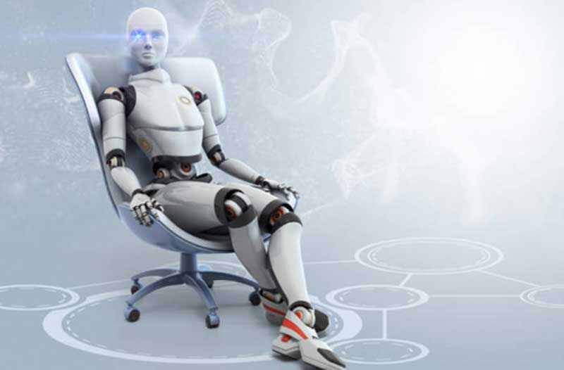 White robot sitting in office chair