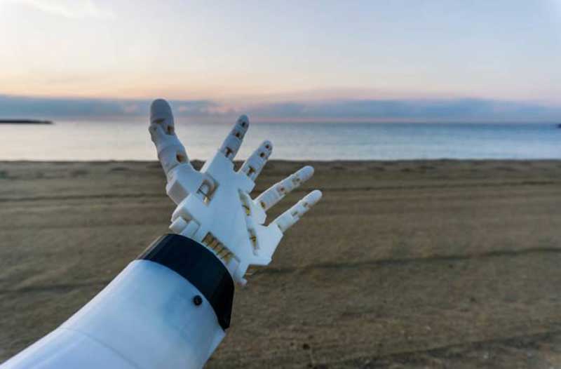 robot hand reaching out to the sea