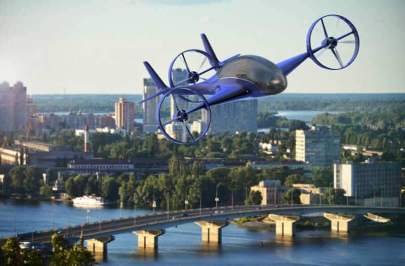 A blue futuristic flying vehicle with propellers on both wings and one close to the tail