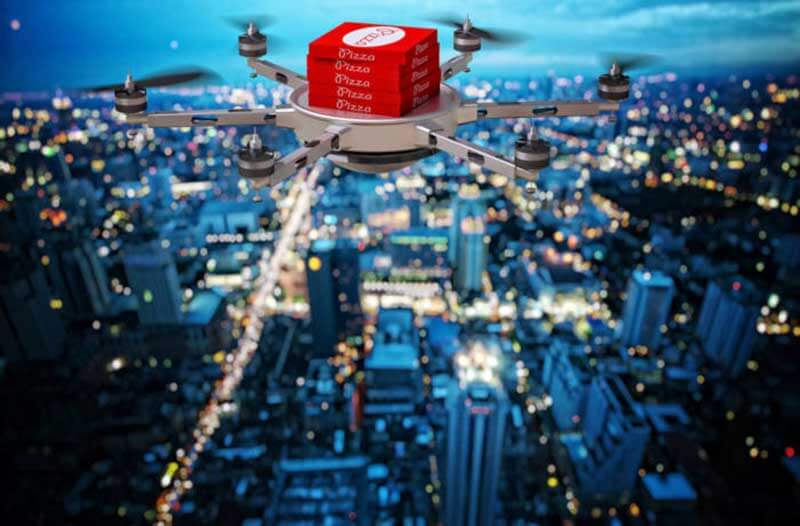 Pizza delivery drone flying over a city at night