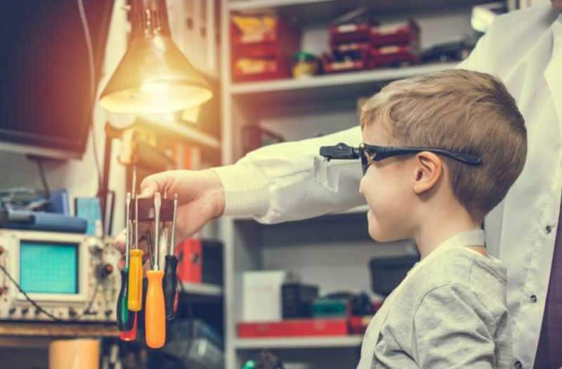 Child with protective glasses in lab