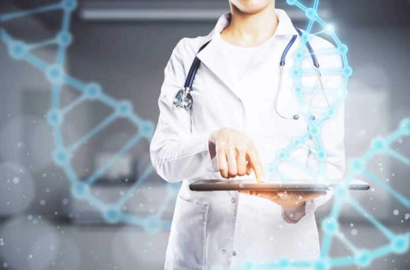 Woman in lab coat holding tablet with digital DNA