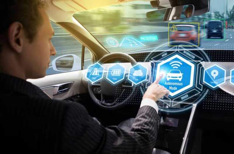 Man sitting in a self-driving car and choosing the autonomous mode on a holographic display in front of him