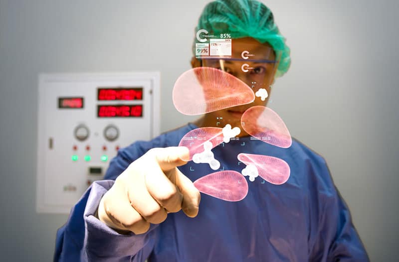 A medical professional interacting with a digital interface that's showing red blood cells