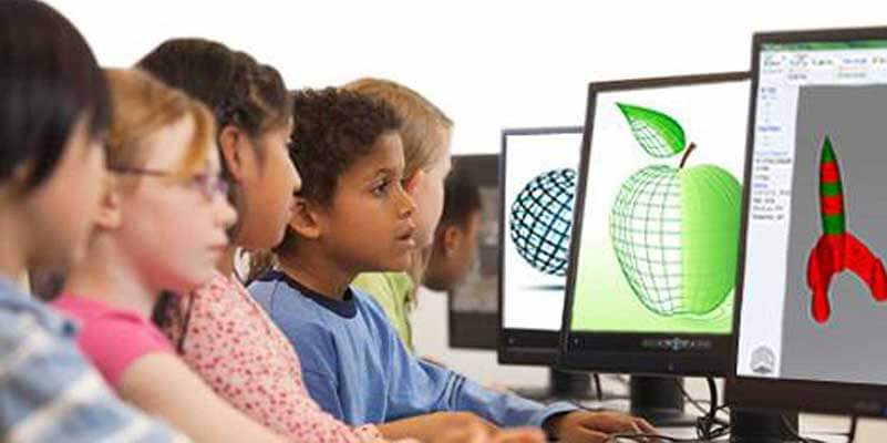 Six children in front of computer screens