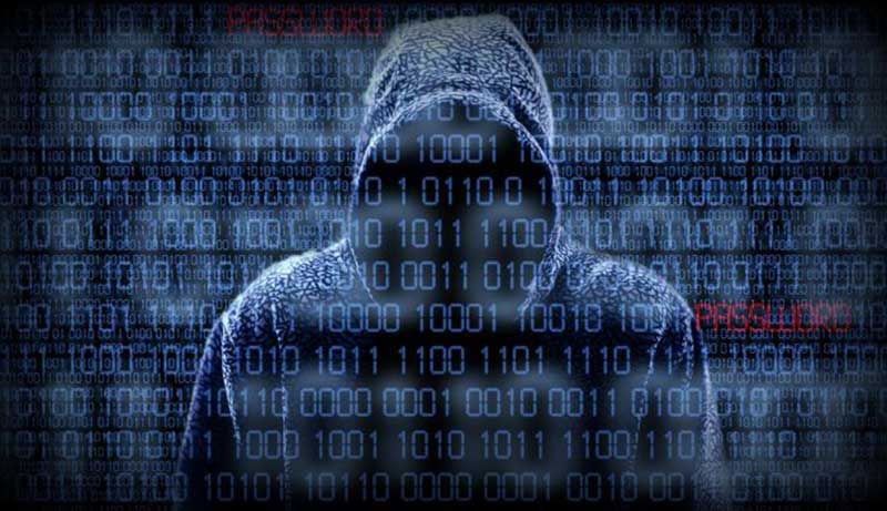 A hacker in a hoodie with his face covered, overlaid with 0s and 1s and the word password