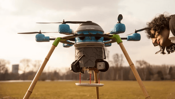 A man inspecting a drone placed in a field