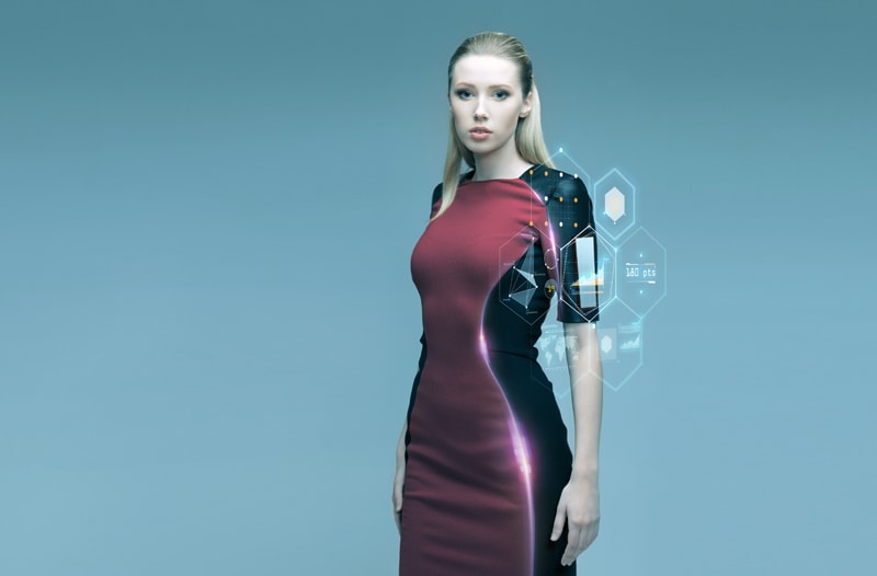 Woman wearing a red and black dress made from smart fabric, fitted with technology
