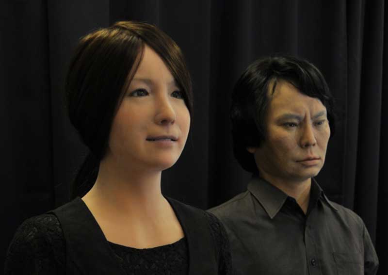 Two realistic humanoid robots standing side-by-side