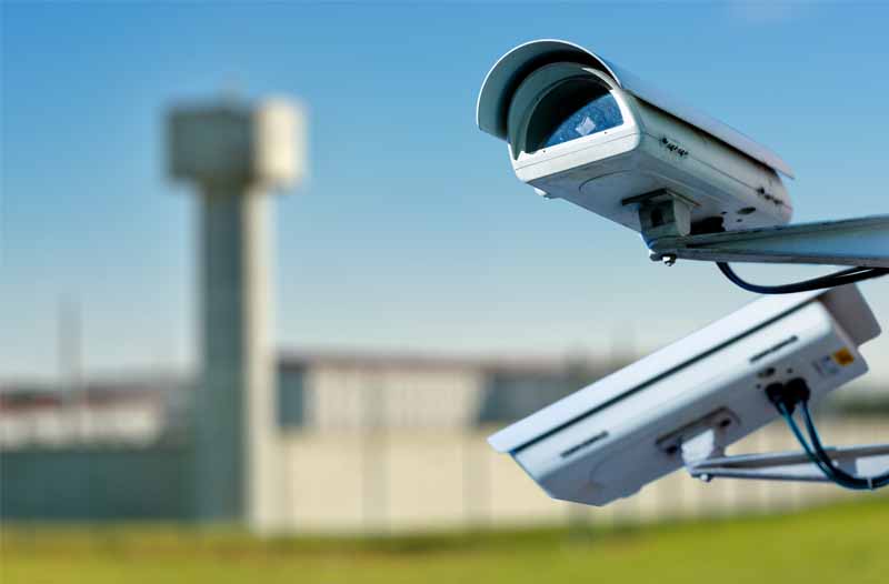 Surveillance system with two cameras installed outside a prison