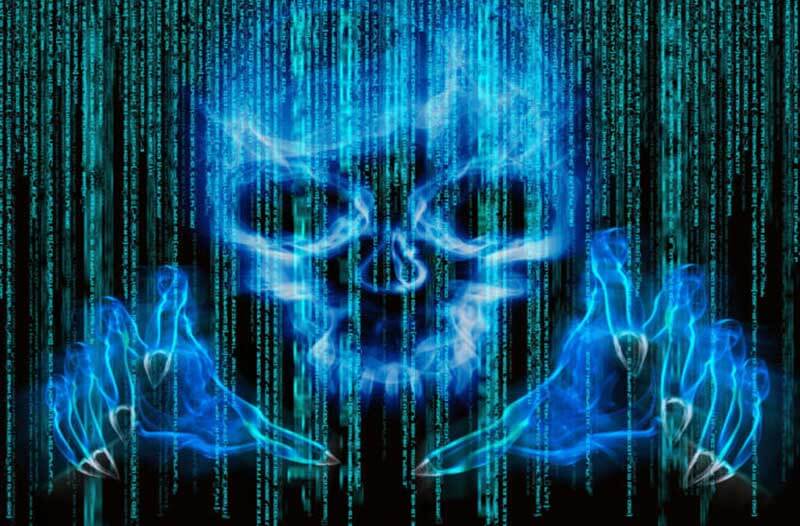 A digital image of a skull and two hands on a computer screen with binary code