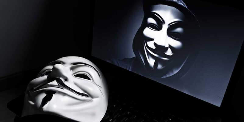 Computer screen with white Anonymous mask