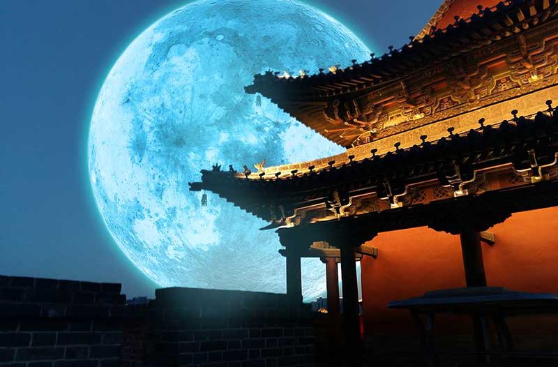 Full moon rising behind Chinese temple