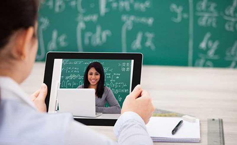 Man holding tablet showing woman with laptop