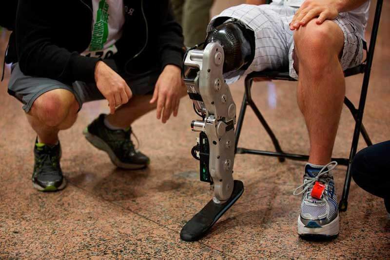 A man with a bionic leg sitting in a chair