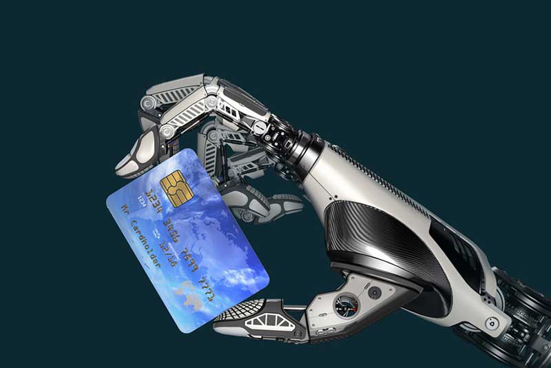  A robotic hand holding a credit card