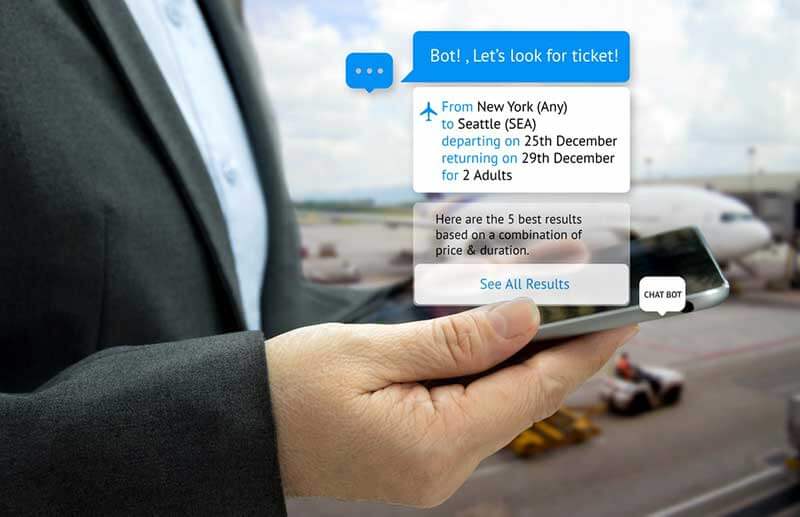 Close-up of a hand holding a smartphone at an airport and interacting with a chatbot to book a flight
