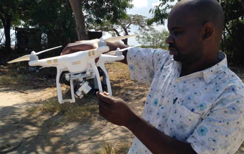  Man wearing a short-sleeve shirt holding a drone