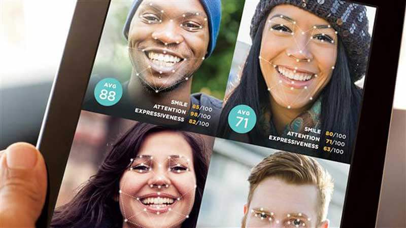 A smartphone screen showing four images of people with mapped faces 