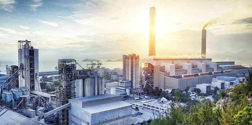 Industrial production plant with chimneys and smoke