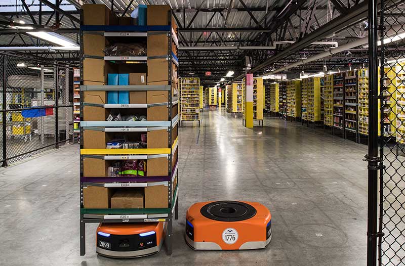 Amazon warehouse with boxes on shelves and orange robot