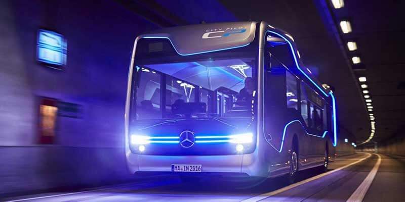 A bus driving through a tunnel, with futuristic blue lines running down its side