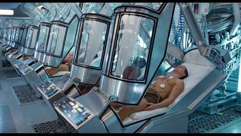  Line of open sleeping pods inside a spaceship, with people sleeping inside of them