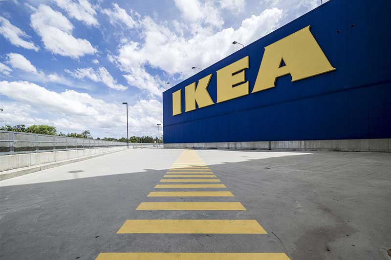 An IKEA retail store and its parking lot on a sunny day