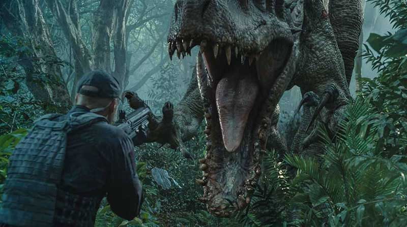 A man with a rifle pointing at a dinosaur in a movie scene 