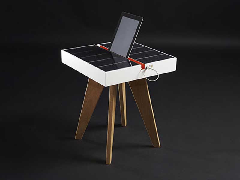table with a charging station and a tablet plugged in