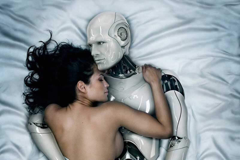 A naked woman hugging a robot in bed with satin sheets