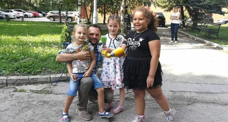 Three kids and a man in the street