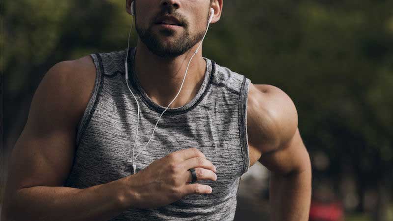 A man running with a black smart ring on his right hand