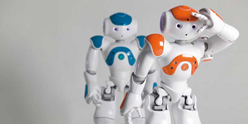 Two plastic robots in white/orange and white/blue