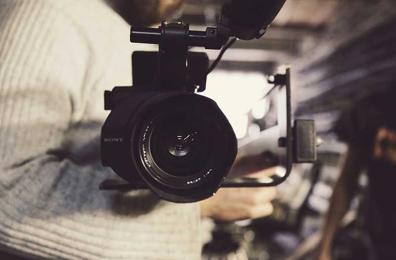 Man in white shirt with photocamera