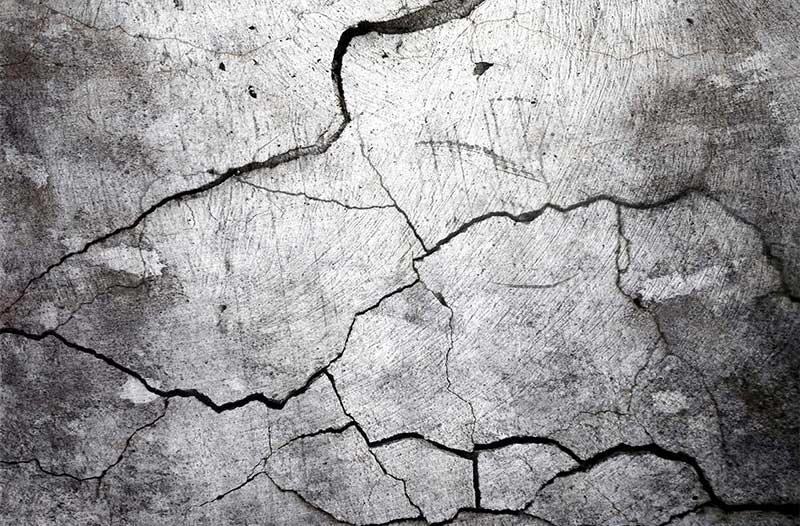 Grey cement floor with cracks