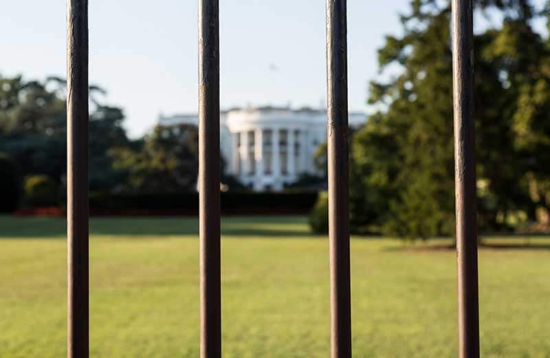 A view of the White House through the security fence surrounding it