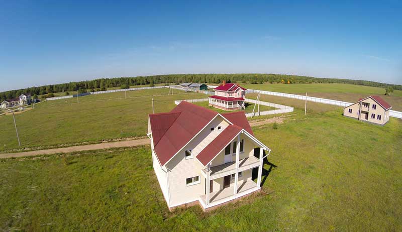 Neighbourhood of two-storey houses surrounded by grassland