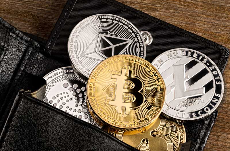 Black wallet with cryptocurrency coins